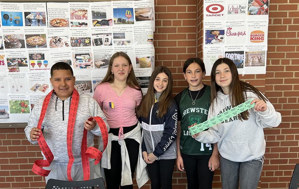 students pose with raffle tickets for Ukraine fundraiser